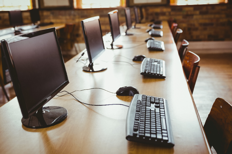 Close-up of a Chairman Conferencing System unit with priority control button and gooseneck microphone on a polished boardroom table